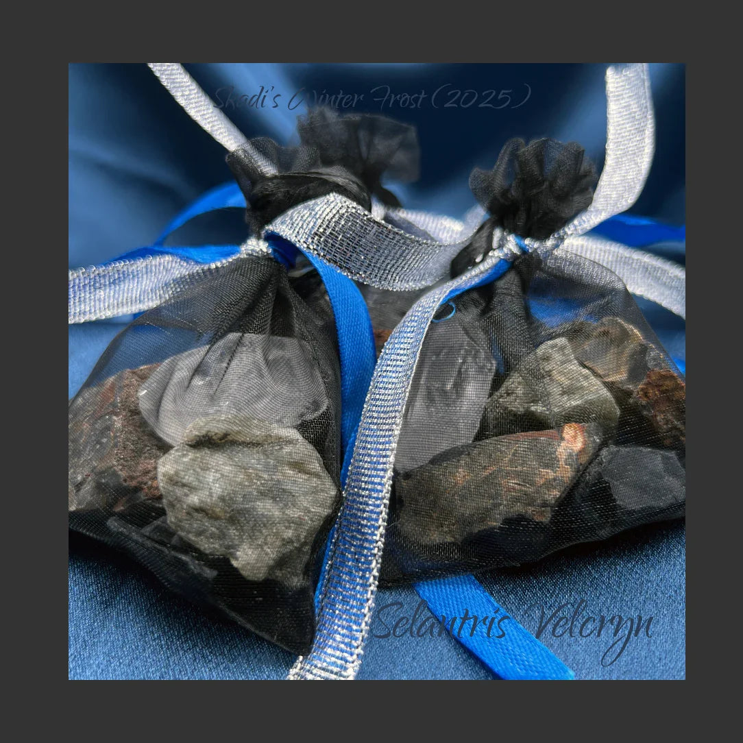Decorative pouch of stones and ribbons on a blue background