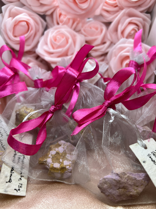 Decorative crystals with pink ribbons and flowers.