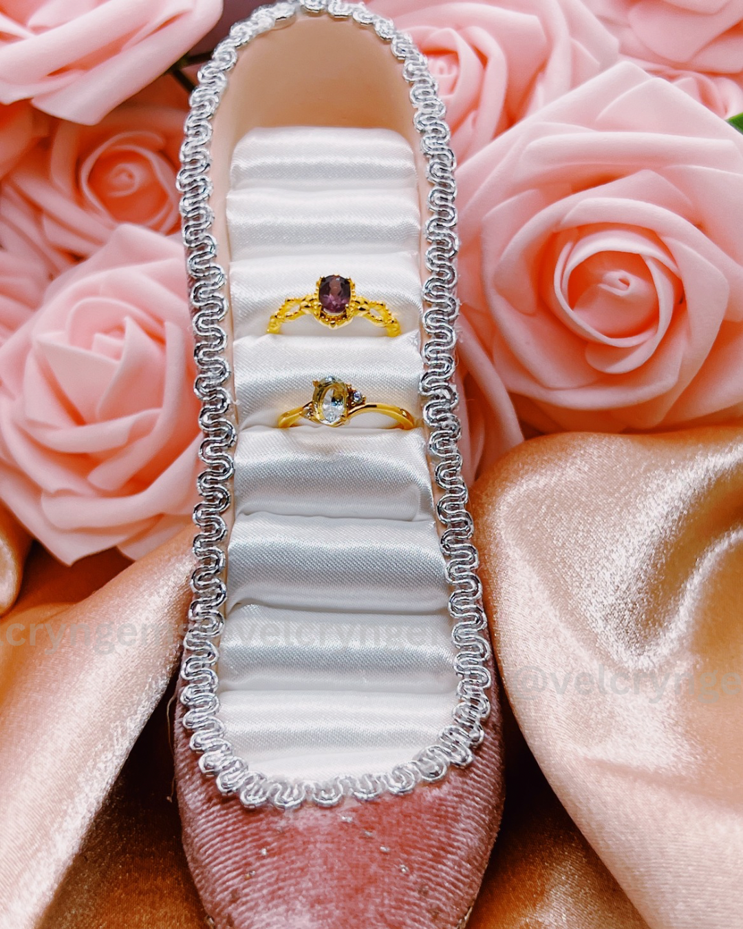 Jewelry box with rings on a bed of pink roses