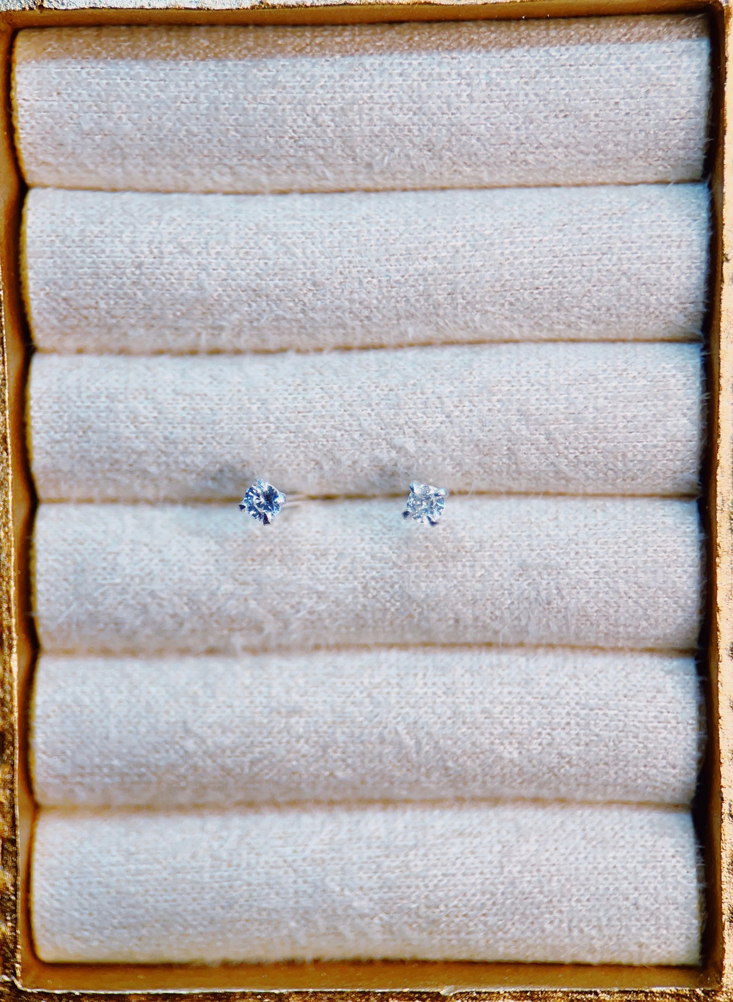 Pair of silver topaz earrings on a textured white surface