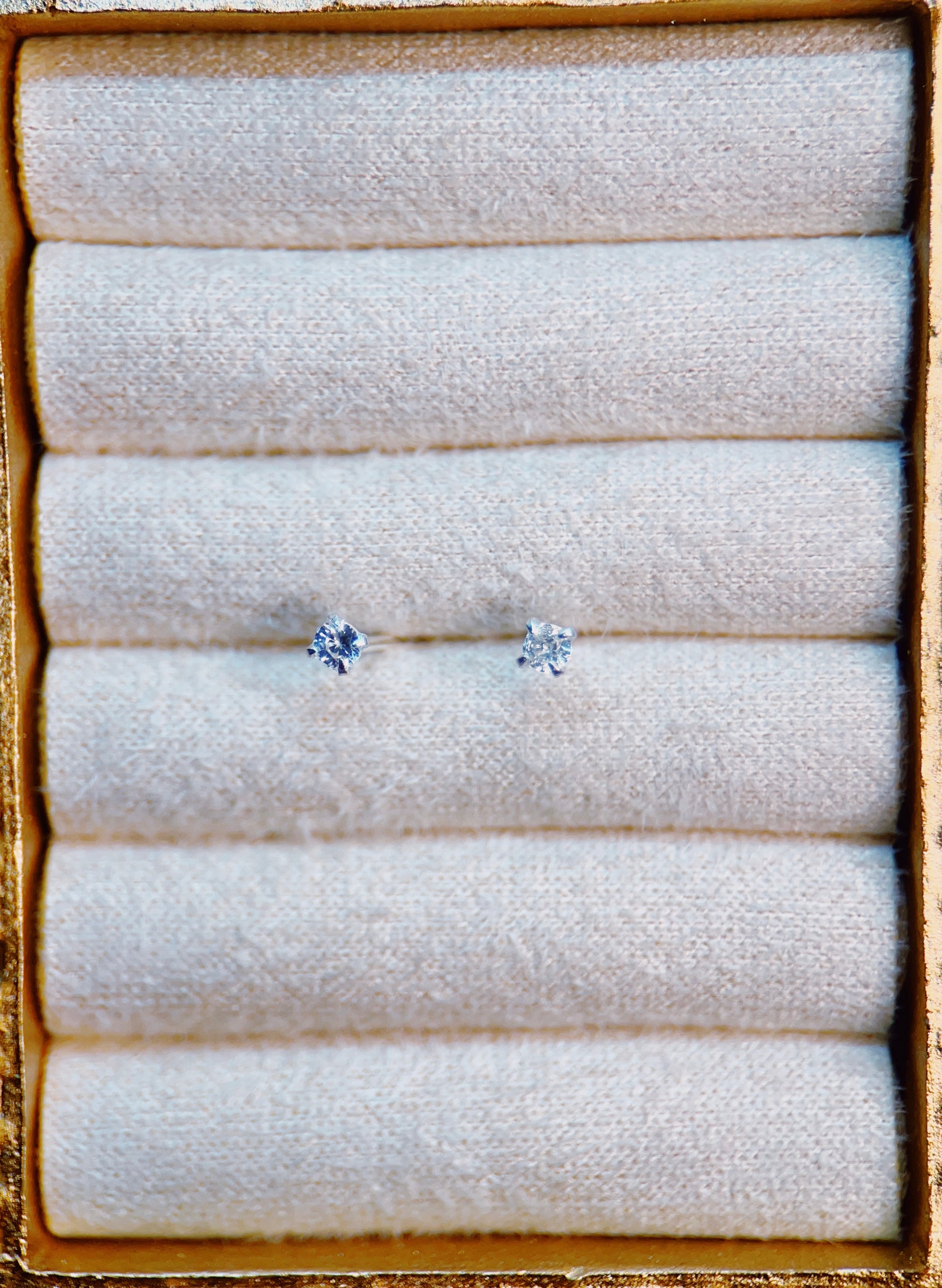 Pair of silver topaz earrings on a textured white surface