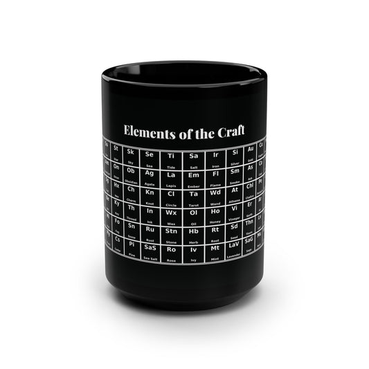 Black ceramic coffee mug with a large handle, shown on a white background. A white “periodic table” style graphic is printed on the side, labeled “Elements,” with grid squares for witchy terms like moon, sun, quartz, amethyst, sigil, hex, key, water, mist, fog, frankincense, myrrh, and cedar.