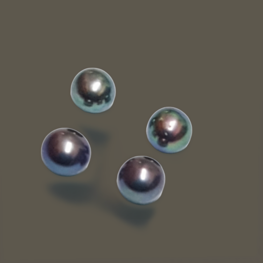 Four round, dark iridescent pearls on a muted gray background, each with a glossy highlight and subtle teal-violet sheen, arranged in a loose diamond pattern with soft shadows beneath.
