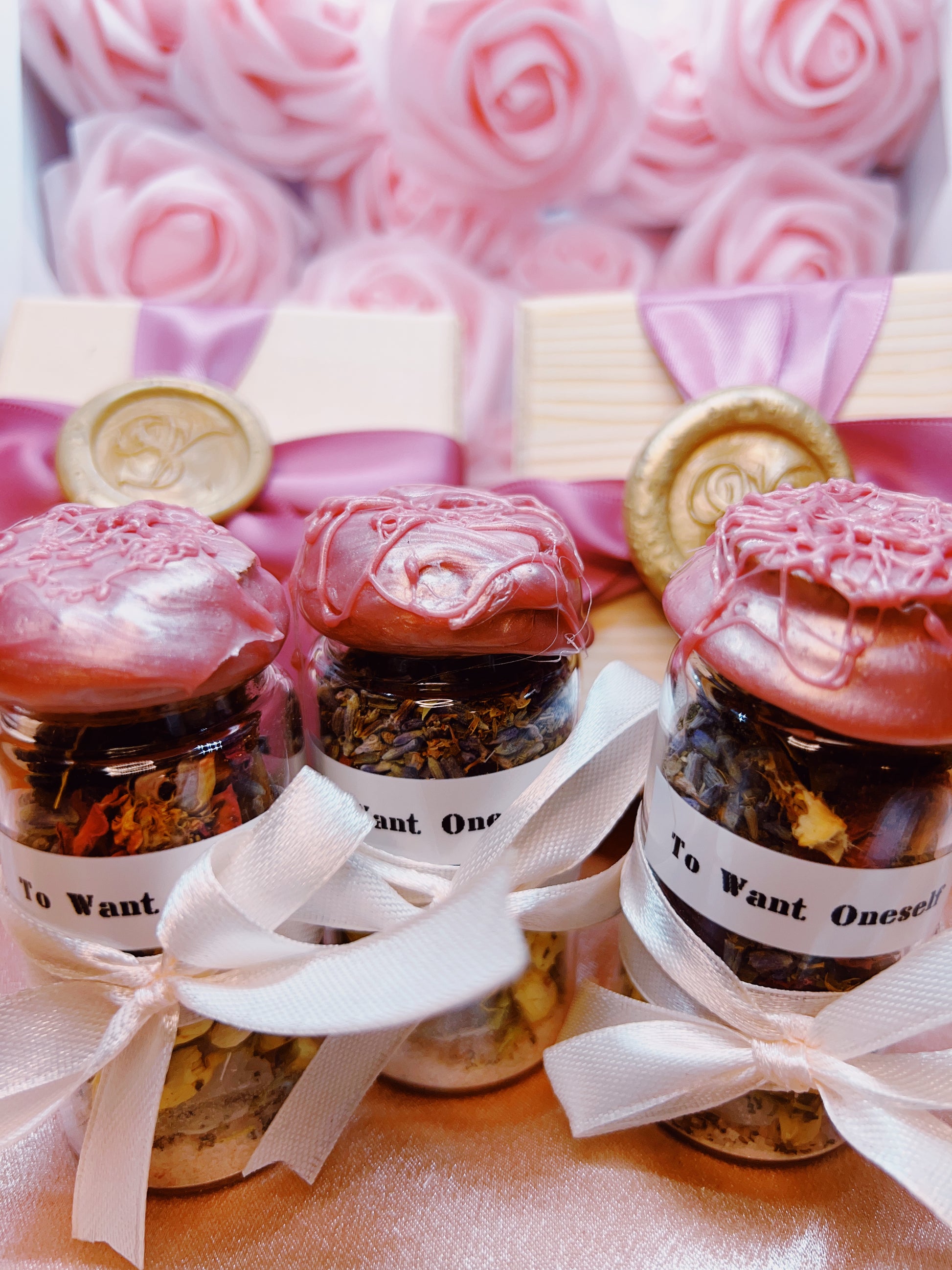 Spell Jars with decorative lids and ribbons on a pink floral background